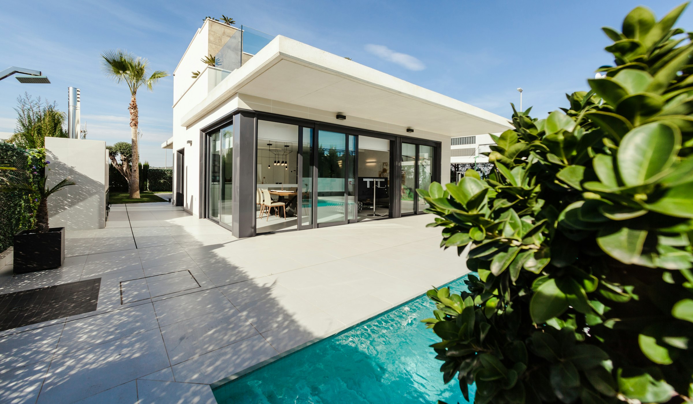 Contemporary residential building with pool and hardscape terrace.