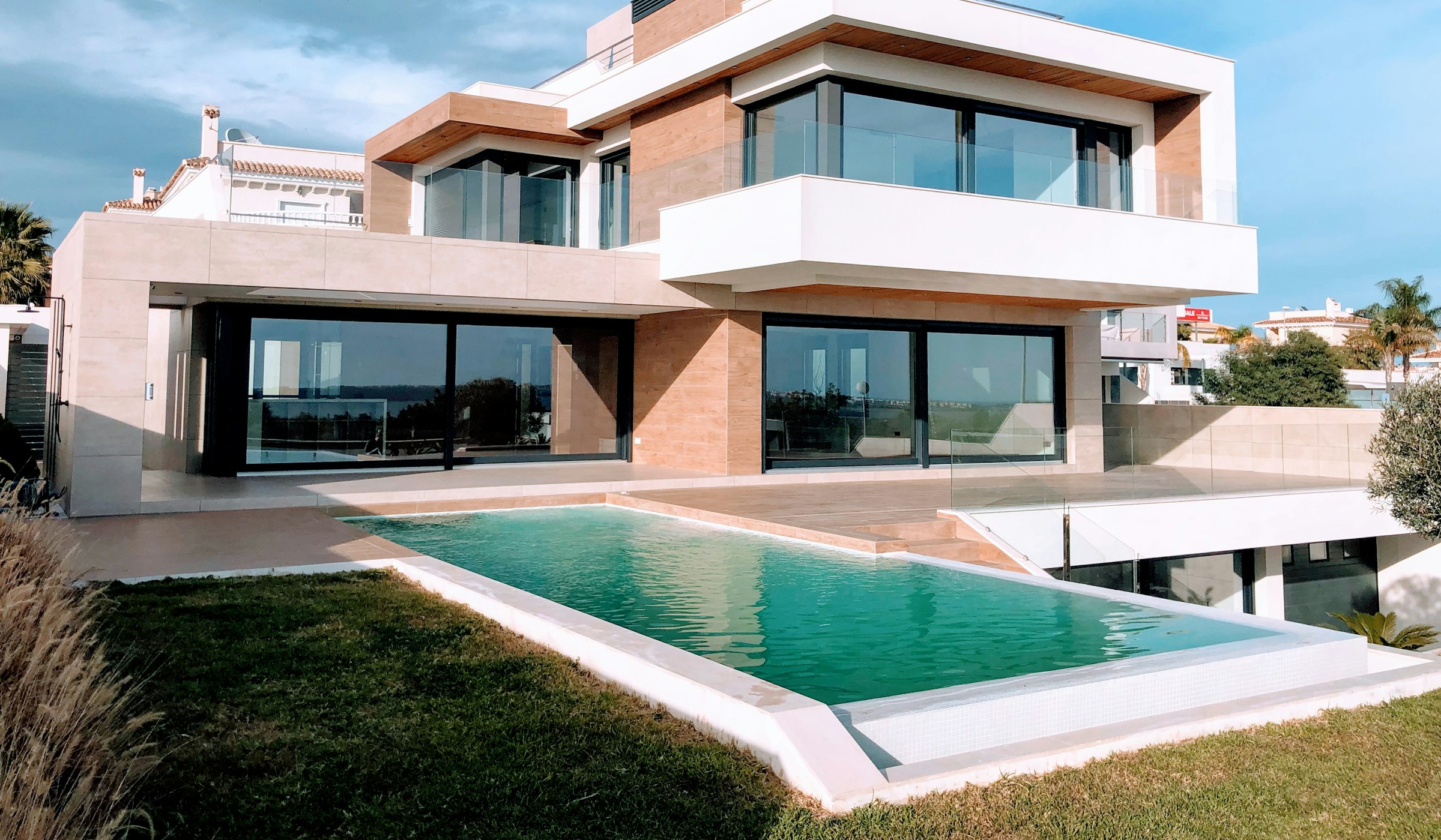 Modern architecture with an infinity pool overlooking the coastline.