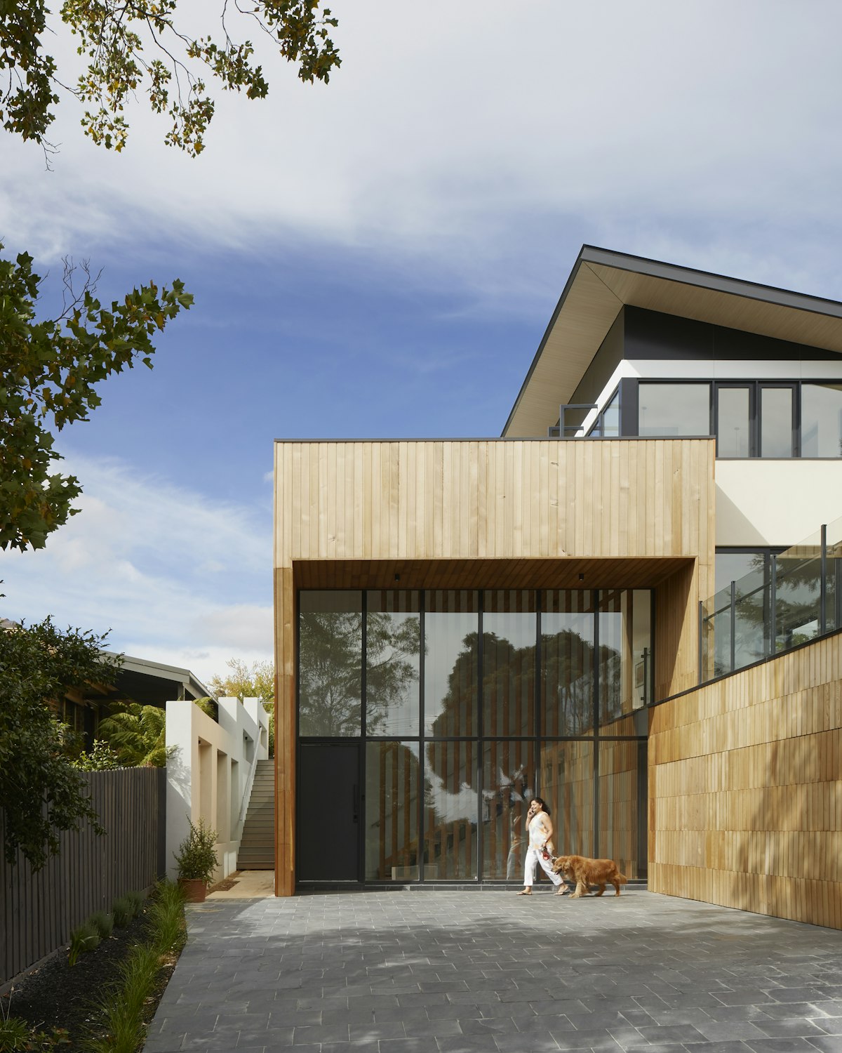Gravel and planted entrance courtyard beside the pavilion facade.