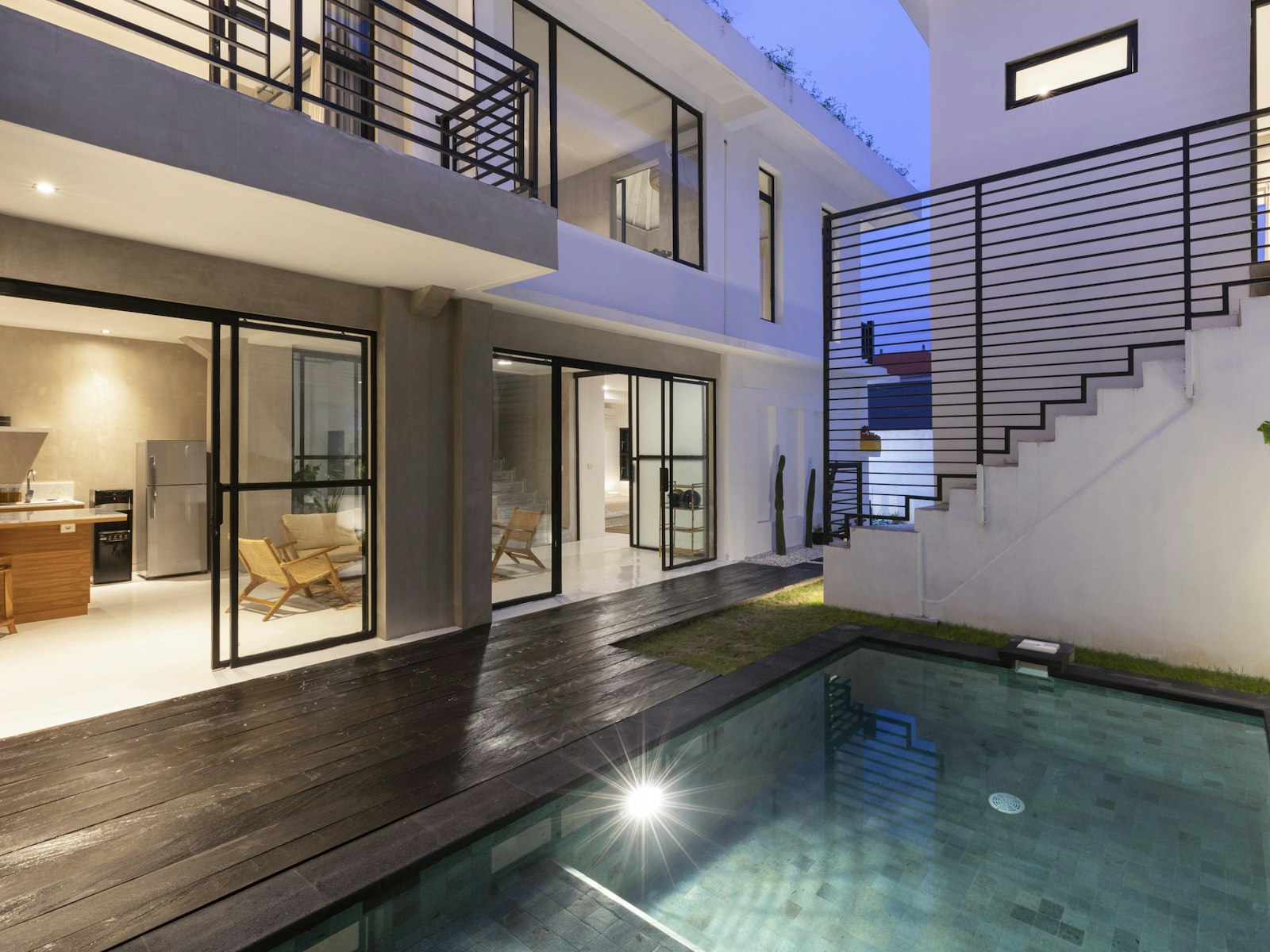 Timber deck and pool terrace lit for evening use.