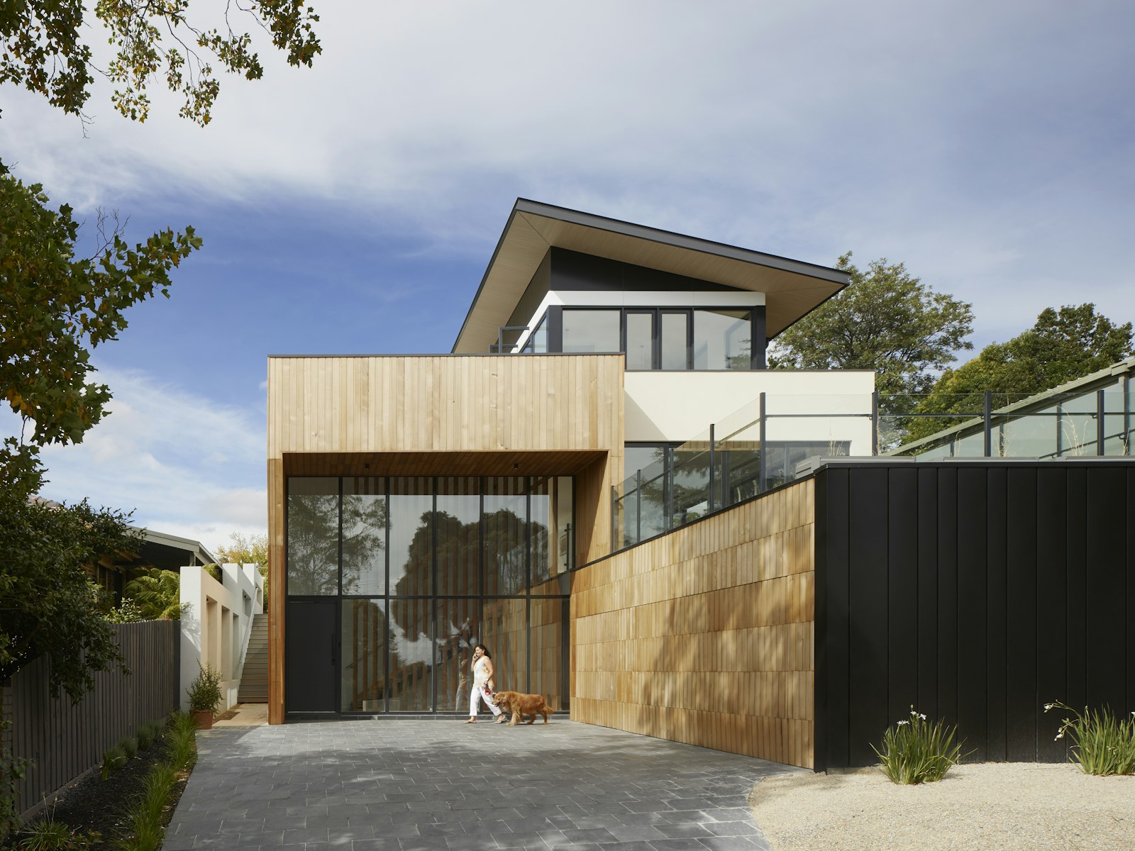 Dark architectural facade with warm entrance lighting at dusk.
