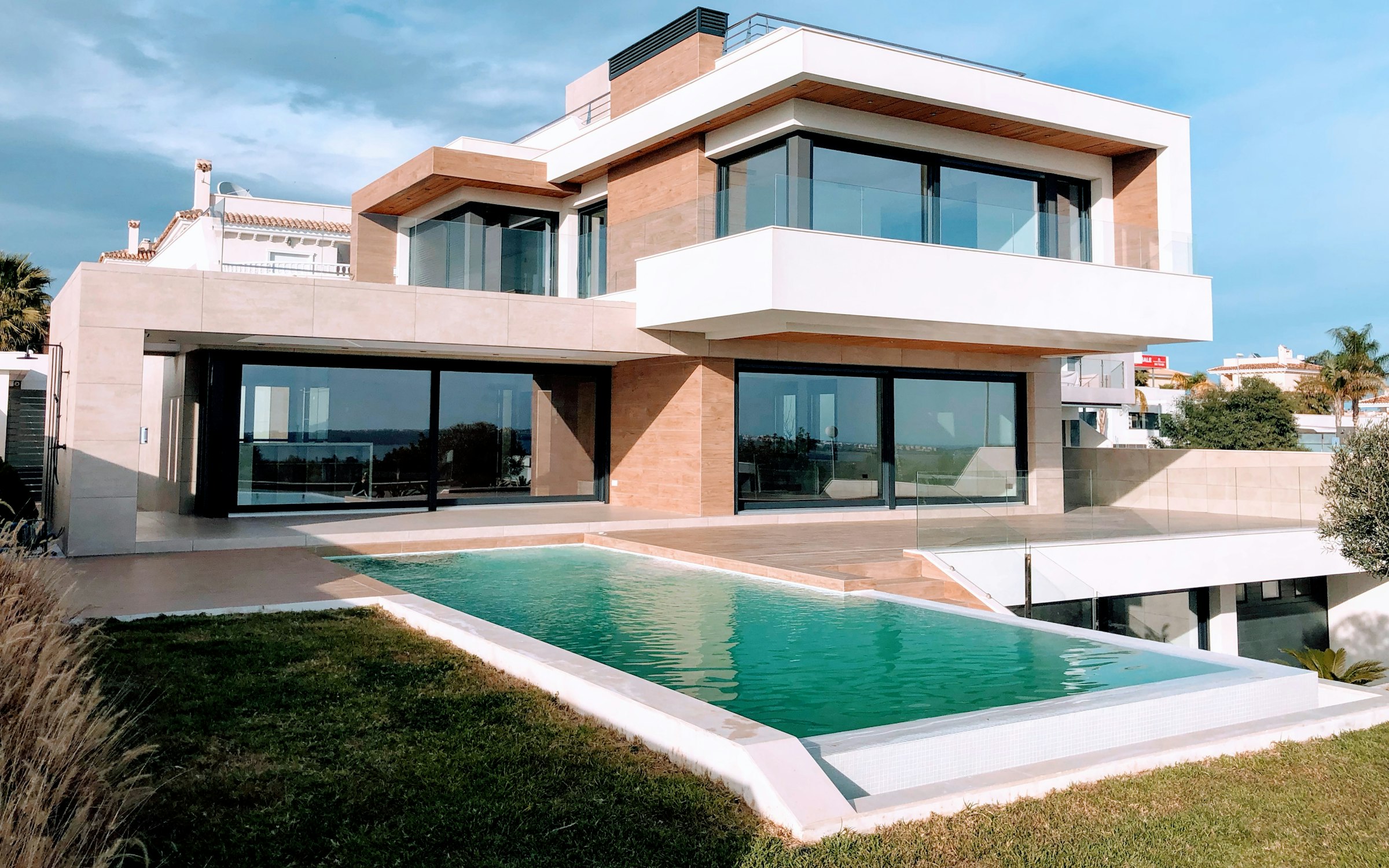 Contemporary building with an infinity pool overlooking the coastline.