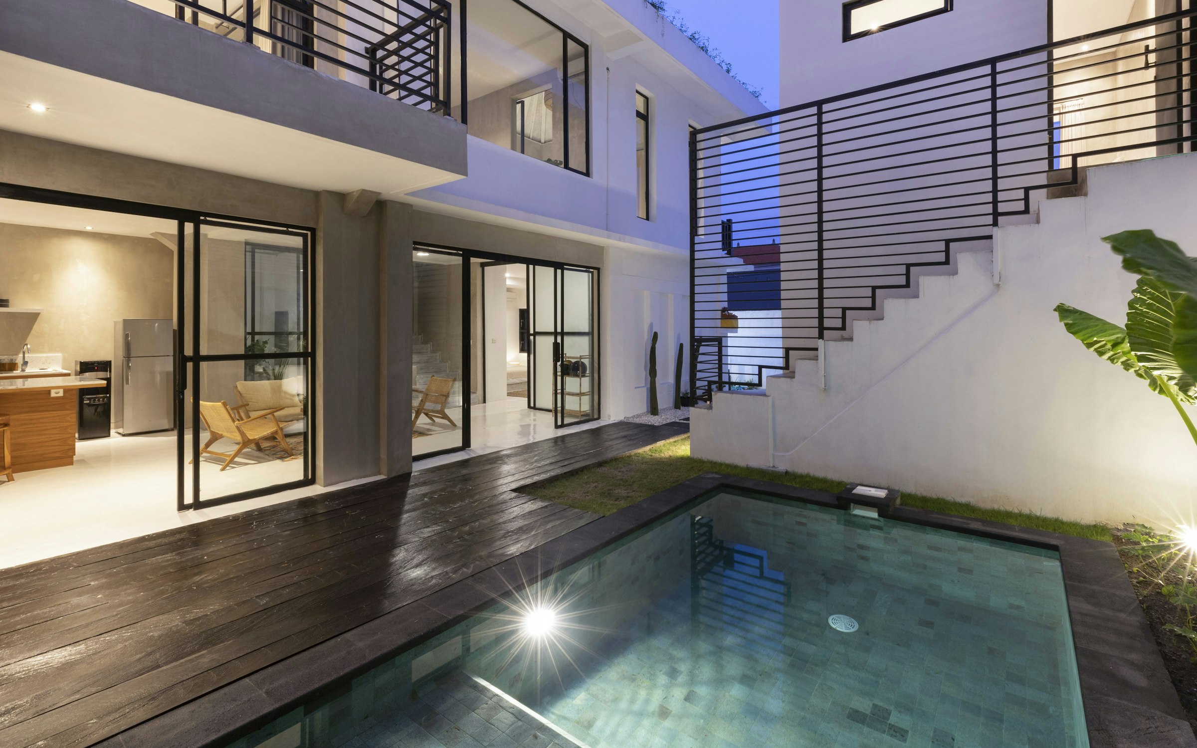 Sunken pool courtyard with timber decking, framed by hotel guest rooms above.