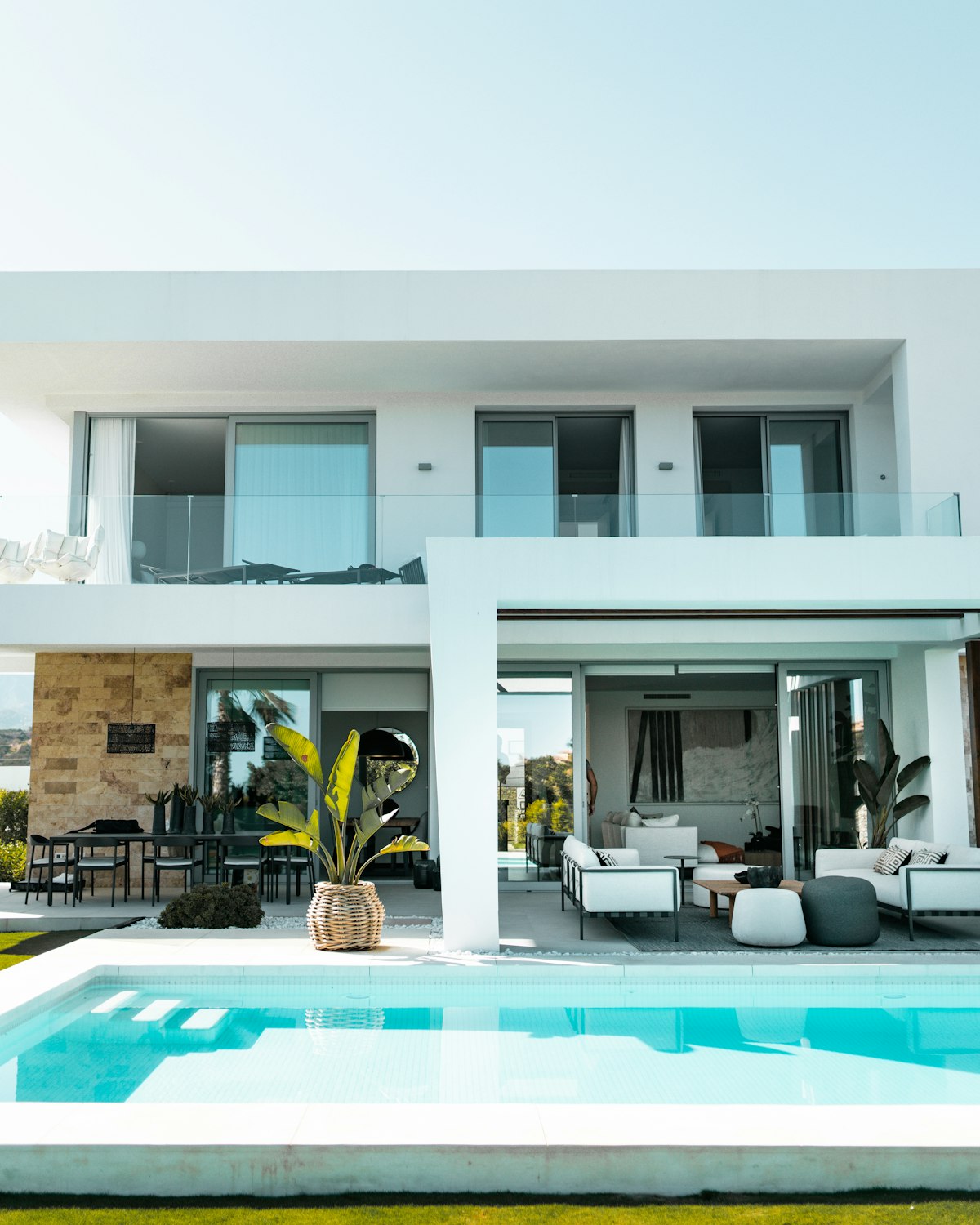 Villa architecture with a pool terrace and loungers.
